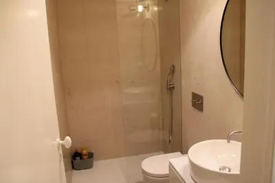 a bathroom with a shower and a toilet and a sink at ALMADA LOFT LIVING by We Do Living in Porto