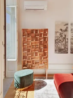 a living room with a couch and a ottoman at Classic loft in fully renewed building at Batalha in Porto