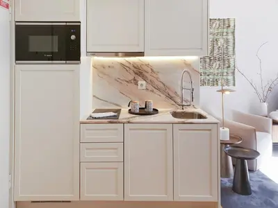 a white kitchen with a sink and a microwave at Classic loft in fully renewed building at Batalha in Porto