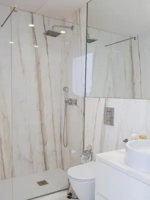 a bathroom with a shower and a toilet and a sink at Classic loft in fully renewed building at Batalha in Porto