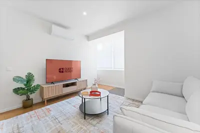 a living room with a white couch and a tv at GuestReady - Marble Branch in Porto
