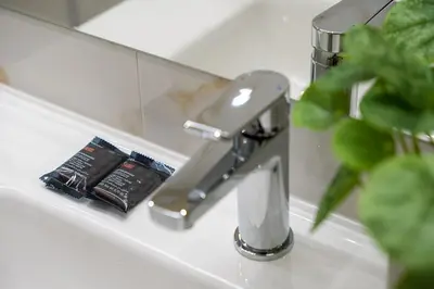 a bathroom sink with a faucet and a cell phone at GuestReady - Marble Branch in Porto