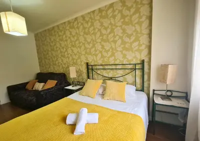 a bedroom with a bed with two crosses on it at D Joao Premium Suite Bolhao Metro in Porto