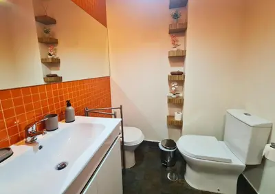 a bathroom with a white toilet and a sink at D Joao Premium Suite Bolhao Metro in Porto