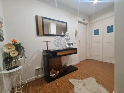 a living room with a mirror on the wall at D Joao Premium Suite Bolhao Metro in Porto