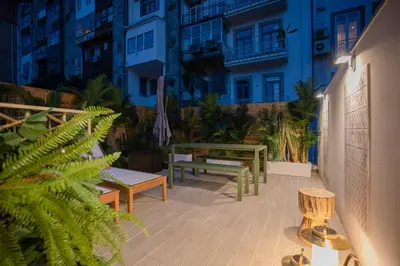 a patio with benches and plants in a building at GuestReady - Soho urban retreat in Porto