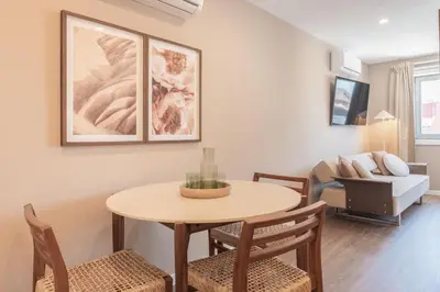 a living room with a table and chairs and a couch at Uma Poveiros in Porto