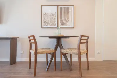 a dining room table with two chairs and a table at Uma Poveiros in Porto