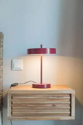 a lamp sitting on top of a wooden table at Uma Poveiros in Porto
