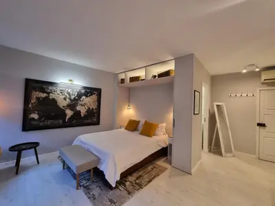 a bedroom with a bed and a painting on the wall at Lovely Studio in the Heart of Historic Porto in Porto