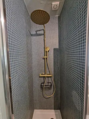 a shower with a shower head in a bathroom at Lovely Studio in the Heart of Historic Porto in Porto