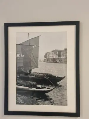 a framed picture of two boats in the water at Lovely Studio in the Heart of Historic Porto in Porto