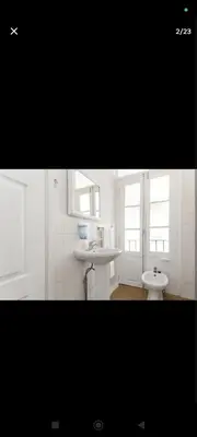a white bathroom with two sinks and two windows at portochique AL7 in Porto