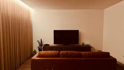 a hallway with white cabinets and a teddy bear on the floor at Music Apartment II in Bicas