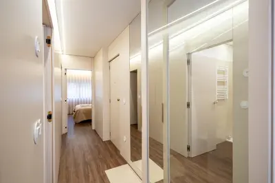 an empty kitchen with a table and chairs in a room at Music Apartment II in Bicas