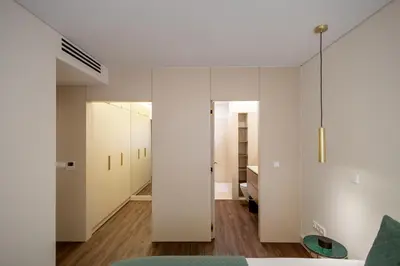 a dining room with a wooden table and chairs at Music Apartment II in Bicas