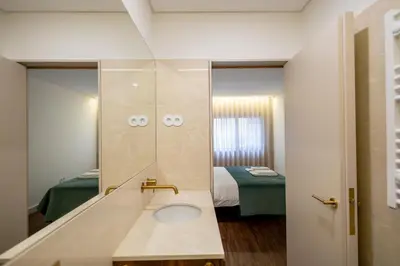a bedroom with a bed with a light above it at Music Apartment II in Bicas