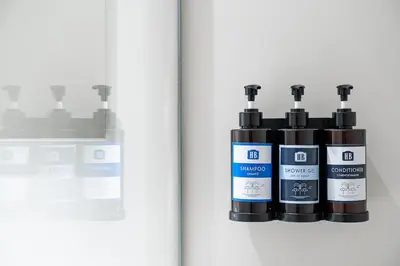 a group of three bottles of hair products on a wall at Unique Luxury and Quiet in Porto Best Location in Porto