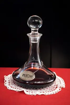 a glass bottle sitting on a table with a label at Porto Ribeira Moments - Apartment with lift in Porto