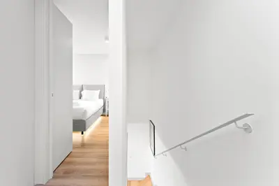 a white room with a bed and a mirror at Stay Bonjardim - Modern Garden Duplex N in Porto