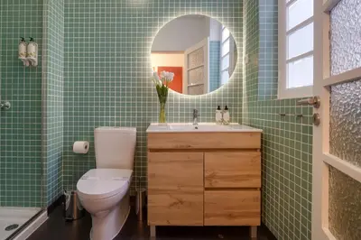 a bathroom with a toilet and a sink and a mirror at Duque 3 Luxury Apartment Downtown Porto near Metro in Porto