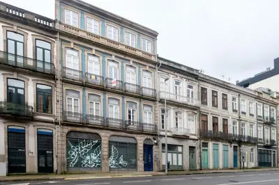 an old building with graffiti on the side of it at Duque 3 Luxury Apartment Downtown Porto near Metro in Porto