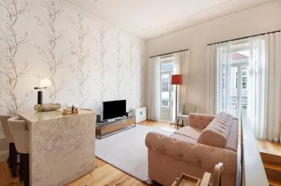 a living room with a couch and a tv at Alma D'oporto 556 – Elegant T1 in Porto