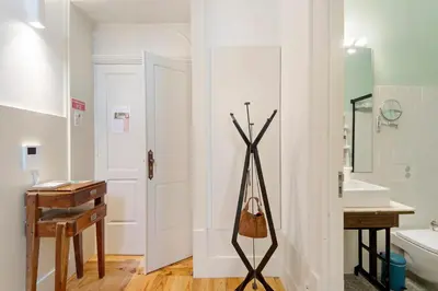 a bathroom with a white door and a sink at Alma D'oporto 556 – Elegant T1 in Porto