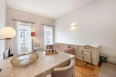 a living room with a large marble table and chairs at Alma D'oporto 556 – Elegant T1 in Porto