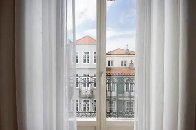 a window with a view of a building at Alma D'oporto 556 – Elegant T1 in Porto