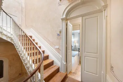 a hallway with a spiral staircase in a home at Alma D'oporto 556 – Elegant T1 in Porto