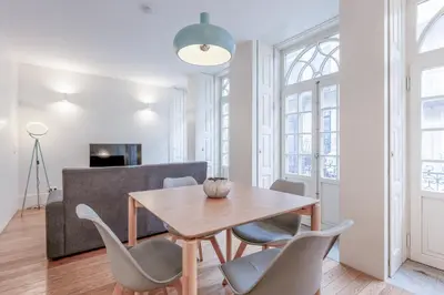 a dining room with a table and chairs at Modern Flat With Balcony on Rua das Flores - 1st in Porto