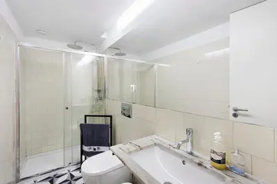 a white bathroom with a toilet and a sink at Breiner House Porto in Porto