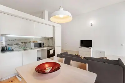 a kitchen and living room with a wooden bowl on a table at Breiner House Porto in Porto
