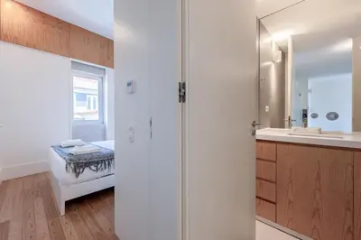 a bathroom with a sink and a mirror at Modern Flat with balcony on Rua das Flores - 5th in Porto