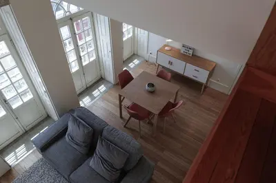 an overhead view of a living room with a table and chairs at Modern Flat with balcony on Rua das Flores - 5th in Porto