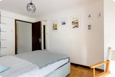 a bedroom with a bed and a white wall at Full 3-Room Apt Downtown Casa do Livro Boavista in Porto