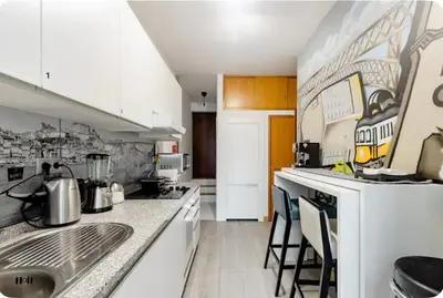 a kitchen with white cabinets and a counter top at Full 3-Room Apt Downtown Casa do Livro Boavista in Porto