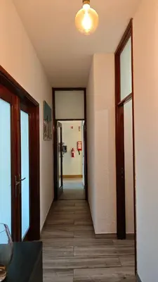 an empty hallway with a hallway leading to a room at Full 3-Room Apt Downtown Casa do Livro Boavista in Porto
