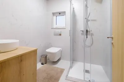a bathroom with a shower and a toilet and a sink at NEW! House with Hot Tub by Douro River & Iconic Bridge in Vila Nova de Gaia