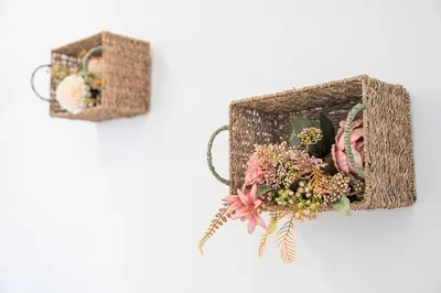 two baskets with flowers on a white wall at GuestReady - Douro D'or Apartments in Vila Nova de Gaia