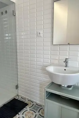 a bedroom with a bed and two windows at Clérigos Cinema Guesthouse in Porto