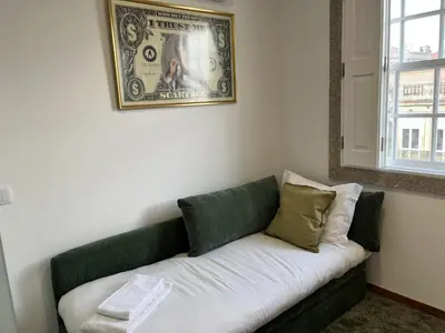 a bathroom with a white toilet and a shower at Clérigos Cinema Guesthouse in Porto