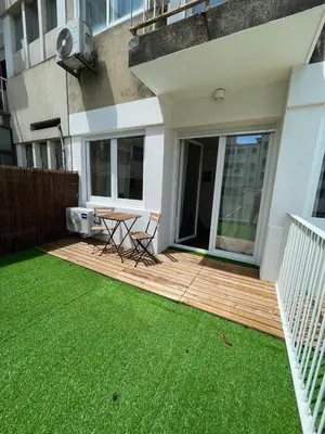 a wooden deck with a table and chairs on it at Bandeira Place in Porto