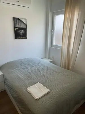 a bedroom with a bed with a towel on it at Bandeira Place in Porto