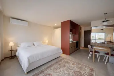 a bedroom with a bed and a desk and a kitchen at Good View Studio in Porto
