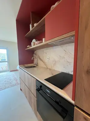 a kitchen with red walls and a stove top oven at Good View Studio in Porto
