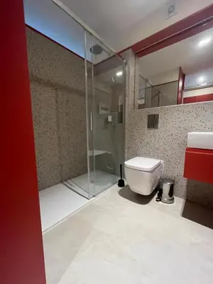 a bathroom with a glass shower and a toilet at Good View Studio in Porto