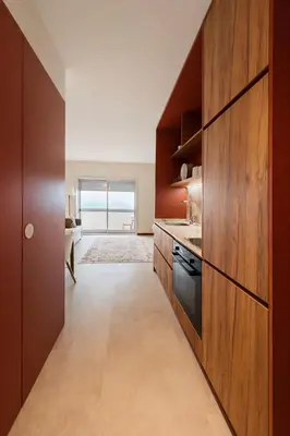 a kitchen with wooden cabinets and a sink at Good View Studio in Porto