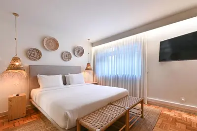 a bedroom with a bed and some plates on the wall at Sleep in Office by ON Apartments in Porto